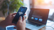 © CNISAK - a Person Using a Smartphone to Connect to WiFi with a Laptop in the Background