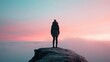 © svastix - A solitary figure stands confidently on a rocky summit, gazing at a breathtaking sunset that paints the sky with vibrant shades of pink, purple, and blue.