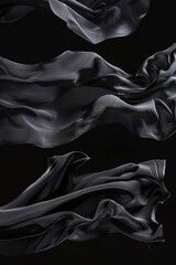 Wall Mural - A close-up view of black fabric blowing in the wind against a black background