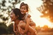© Art Gallery - Asian mother and daughter having fun outside - Portrait of happy woman giving a piggyback ride to cute little girl at park - Indonesian kid with with mom playing outdoor - parenthood, Generative AI