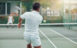 © peopleimages.com - Back, tennis and man with action, playing and competitive with opponent, energy and speed with ball. Outdoor, performance and active in game, people and sport with challenge in court and match