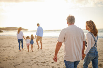 Poster - People, family and generations with walking in beach for bonding, break and holiday in Bali. Parents, grandparents and kids in ocean on sunset for vacation, adventure and journey to relax and fun