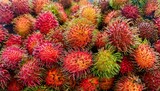 The background of rambutan fruit shows various ripe rambutan fruit filling the background, sales, promotions, wallpaper.