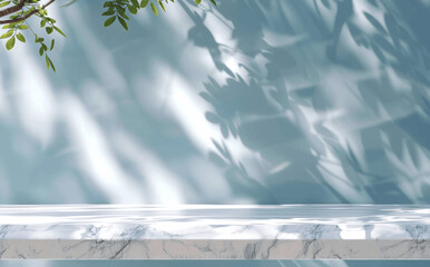 Wall Mural - Abstract White Marble Table with Blurred Foliage Shadow on Light Blue Wall for Product Display