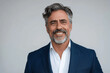 © btiger - Confident Mature Businessman with Gray Hair and Beard in Blue Suit Smiling at Camera Isolated on White Background