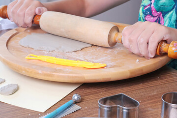 Teenage girl molds clay by using rolling pin at home. Hobbies and tools. Creativity for children, education. 