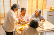 © CandyRetriever  - Group of Happy Asian senior women friends having afternoon tea together at home. Elderly retired woman enjoy and fun indoor lifestyle talking together with drinking tea and eating bakery on the table.