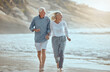 © peopleimages.com - Mature, couple and running on beach with love on retirement vacation, romance and together with fun or freedom. Man, woman and holding hands by ocean on holiday, happy and bonding with energy.