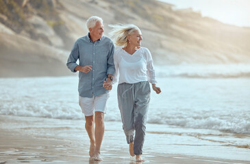 mature, couple and running on beach with love on retirement vacation, romance and together with fun 