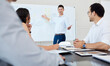 © Clayton D/peopleimages.com - Businessman, talking and presentation in office with whiteboard for teaching, graph and progress report. Male coach, speaker and training workshop for social media strategy, chart and marketing stats