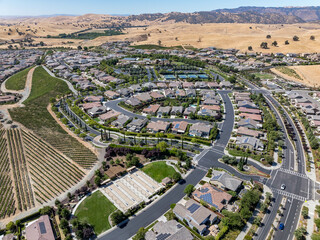 Wall Mural - Aerial images over the Trilogy 55+ and older community in Brentwood, California with beautiful homes with solar, surrounded by hills with vineyards and mt.diablo