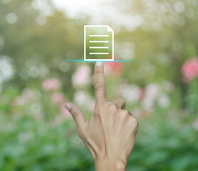 Canvas Print - Hand pressing document flat icon over blur pink flower and tree in park, Technology internet online concept