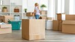 © Bantita - A girl packing moving boxes in a new home, preparing for a move, with several boxes and household items in the background.