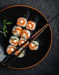 © Johnovich - Sushi composition on black background. The Art of Japanese Cuisine. Food photography for menu and sushi bar decoration