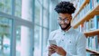 © ZeNDaY - Modern Professional Using Smartphone in Bright Library with Large Windows