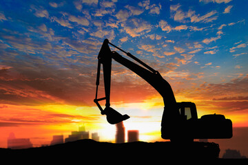 Canvas Print - Crawler excavators silhouette are digging the soil in the construction site. on  sunset background