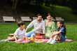 © New Africa - Happy family having picnic together in park