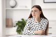 © New Africa - Embarrassed woman in glasses at table in office, space for text