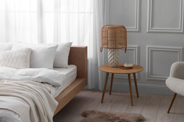 Sticker - Stylish living room interior with bed, bedside table and lamp