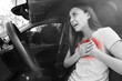 © New Africa - Young woman suffering from heart pain while driving in car