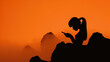 © ChimE - Romantic image of a woman captured in silhouette against a glowing sunset, on a harbor rock wall.