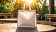 © 9KHOU - Blank white canvas tote bag mockup on a sunlit table, perfect for showcasing designs This eco-friendly product  is perfect for promoting sustainable living simple, and durable design.