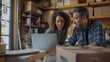 © Daniel - Diverse Small Business Partners Working in Home Garage And Talking. Hispanic Female Manager Filling Online Orders On Laptop. Two Caucasian Friends Packing Products In Boxes For Delivery To Customers.