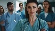 © Sumet - Attractive female doctor standing confidently in front of a diverse medical team, professional hospital environment, modern and vibrant