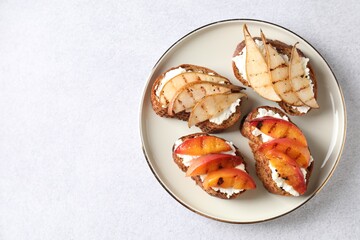 Canvas Print - Delicious bruschettas with ricotta cheese on light grey table, top view. Space for text