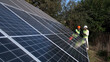© Vladislav - A man and a woman in hard hats discuss work tasks near solar panels on the street. Female environmental engineer talking to investor. Green electricity concept.