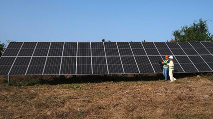 Wall Mural - Architect and engineer when installing solar panels. Man and woman or team of engineers with technology at a meeting or construction planning