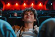 © Igor - Cheerful teenager man is watching movie in the cinema theatre