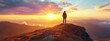 © auttawit - A man stands on a mountain top, looking out at the sun as it sets. The scene is peaceful and serene, with the man alone on the mountain, taking in the beauty of the sunset