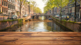 close up of rustic empty wooden table with blurred amsterdam canal background