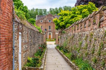 Wall Mural - A view down a path leading away from the Chichester Cathedral in the center of Chichester, Sussex in summertime