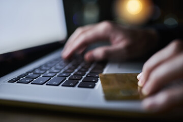 hacker, laptop and credit card fraud for hacking, cloning and identity theft with person typing at n