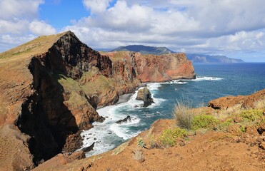 Wall Mural - cliffs surrounded by the sea under cloudy sky in Vereda da Ponta de Sao Lourenco, Madeira, Portugal