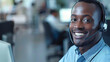 © Mahemud - Close-up of a smiling businessman talking over a headset in a call center.