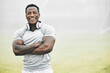 © Courtney/peopleimages.com - Black man, portrait and confidence outdoor for fitness, wellness and health goals achievement in morning. Athlete, face and crossed arms on field for workout, training and exercise with headphones