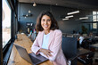 © Stock 4 You - Portrait 30s latin hispanic business woman manager working on laptop computer in modern office. Smiling Indian young businesswoman professional entrepreneur using pc app at workplace looking at camera