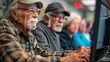 © kanesuan - A senior man teaching a computer class to other elderly individuals, guiding them through basic tasks with patience and expertise. The modern classroom environment and attentive students underscore