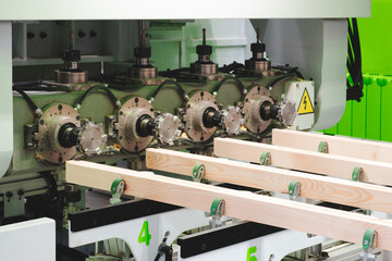 Poster - A stack of wood is being cut by a machine