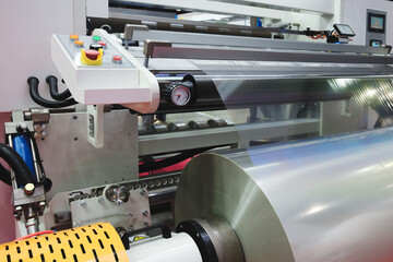 Poster - Automatic polyethylene plastic bag production machine with lighting effect. Close-up of the roller of the plastic bag production machine in the light blue scene. product packaging concept