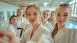 © Damerfie - Group of Young Women in Karate Uniforms Taking a Selfie