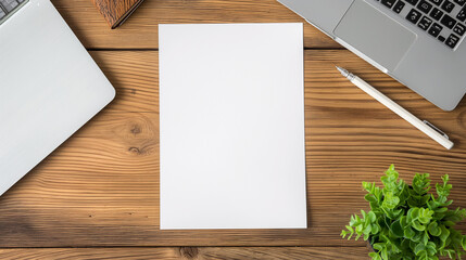 Top view of a pristine, empty blank white vertical resume paper document mockup template on a contemporary wooden office table, with a laptop notebook and a pencil carefully positi