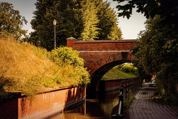 Wall Mural - Old brick gothic bridge over the canal and autumn trees