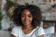 © Akanksha - people, race, ethnicity and portrait concept - happy african american young woman sitting on sofa at home, Generative AI
