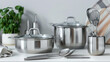 © Mahmud - Stainless steel cooking pots placed on a white induction hob in a modern kitchen, ideal for food preparation.