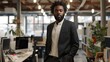 © ANC Media - A Black man in a suit stands in an office with his hands in his pockets