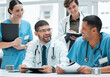 © peopleimages.com - Documents, teamwork and doctors laughing in meeting for medical diagnosis, discussion or paperwork. Joke, happy and people in funny conversation for collaboration, consulting or healthcare service